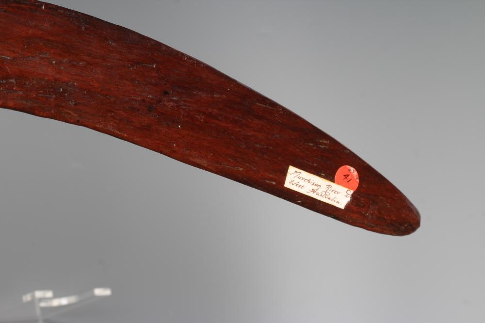 AN ABORIGINAL BOOMERANG with one flat edge and long tooling marks throughout, old label inscribed Image