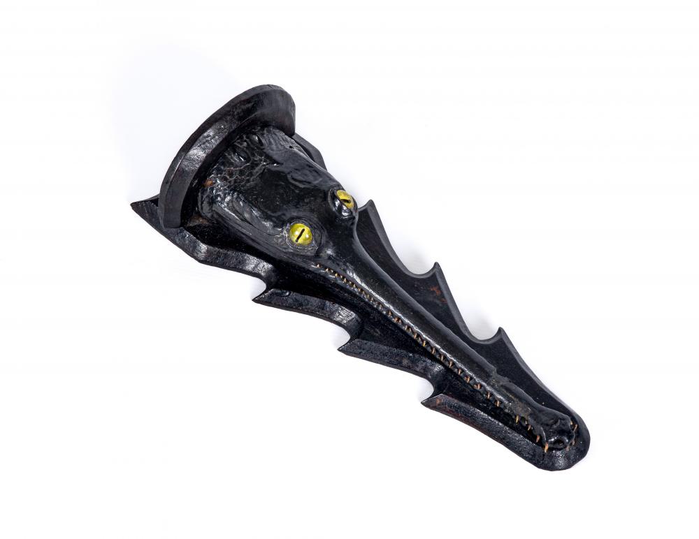 A TAXIDERMY GHARIAL HEAD, 19th century, with realistic amber eyes, mounted on a wooden wall bracket, Image