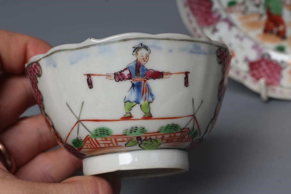 A CHINESE PORCELAIN FAMILLE ROSE TEA BOWL AND SAUCER painted with a tightrope walker and a knife Image