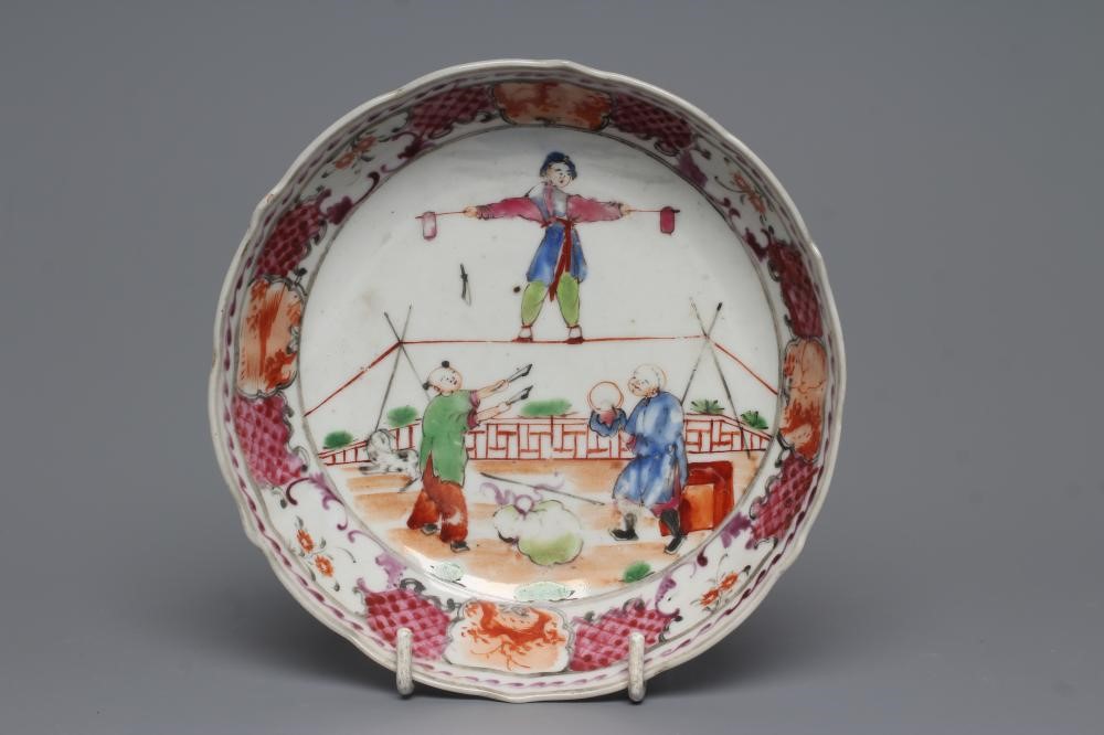 A CHINESE PORCELAIN FAMILLE ROSE TEA BOWL AND SAUCER painted with a tightrope walker and a knife Image