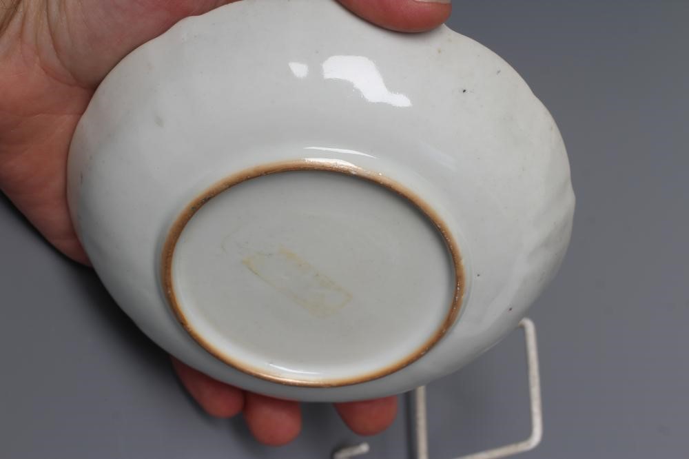 A CHINESE PORCELAIN FAMILLE ROSE TEA BOWL AND SAUCER painted with a tightrope walker and a knife Image