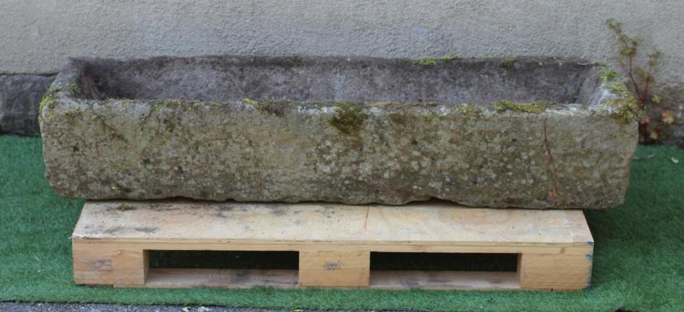 A SANDSTONE TROUGH of rough hewn narrow oblong form, 58" x 16" x 11" (Est. plus 24% premium inc. Image
