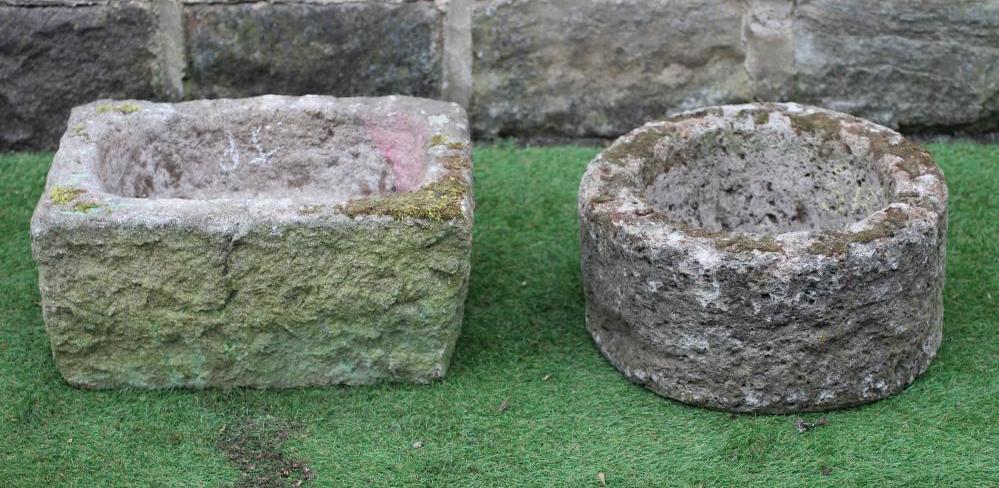 A SANDSTONE TROUGH of rough hewn circular form, 15 1/2" x 8", together with another of oblong form, Image