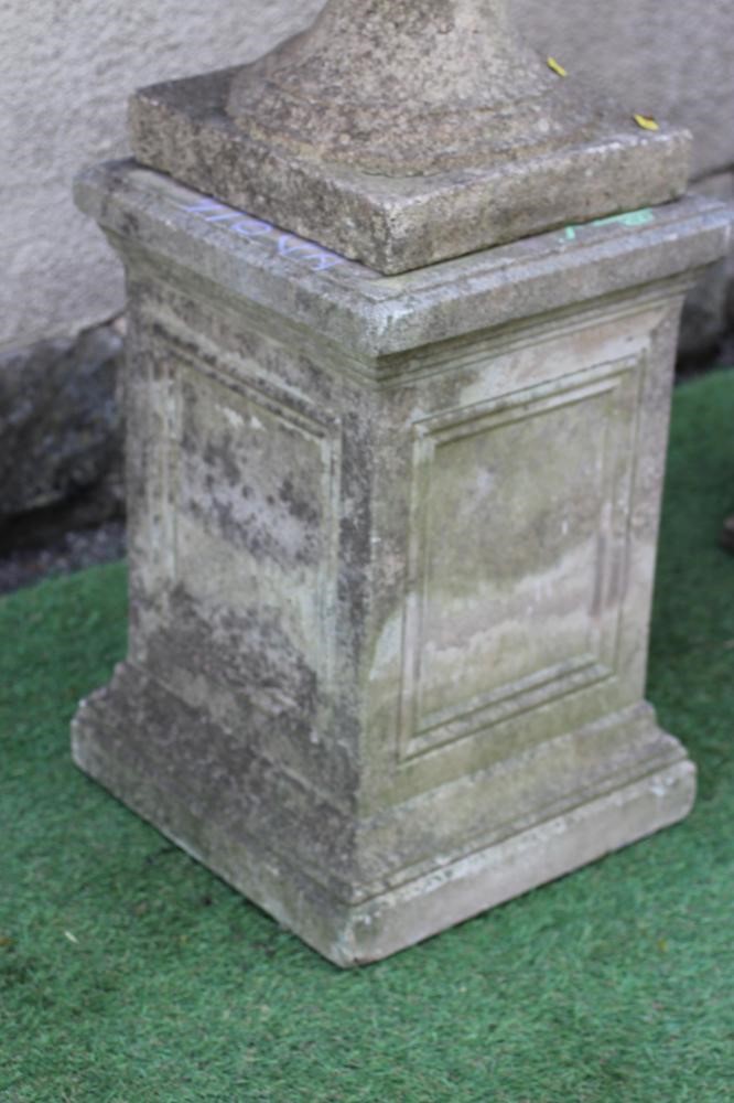 A PAIR OF CAST STONE URNS of half fluted campana form with ovolu moulded rim Image