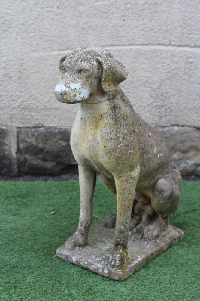 A CAST STONE FIGURE OF A SEATED DOG on an oblong plinth, 18" x 27 1/4" (Est. plus 24% premium inc. Image