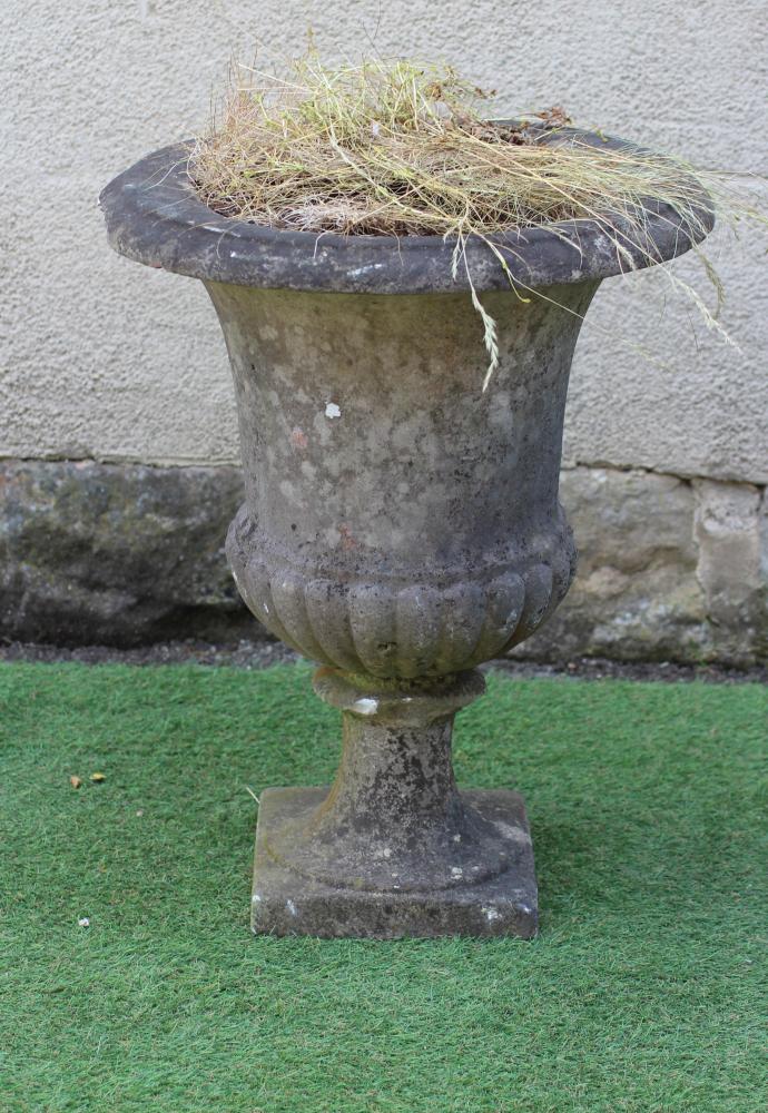 A WHITE MARBLE CAMPANA URN of half fluted plain form with moulded rim, raised on fluted socle and Image