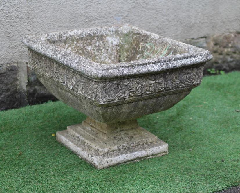 A CAST STONE PLANTER of square form with moulded rim over a band of flower heads, raised on a Image