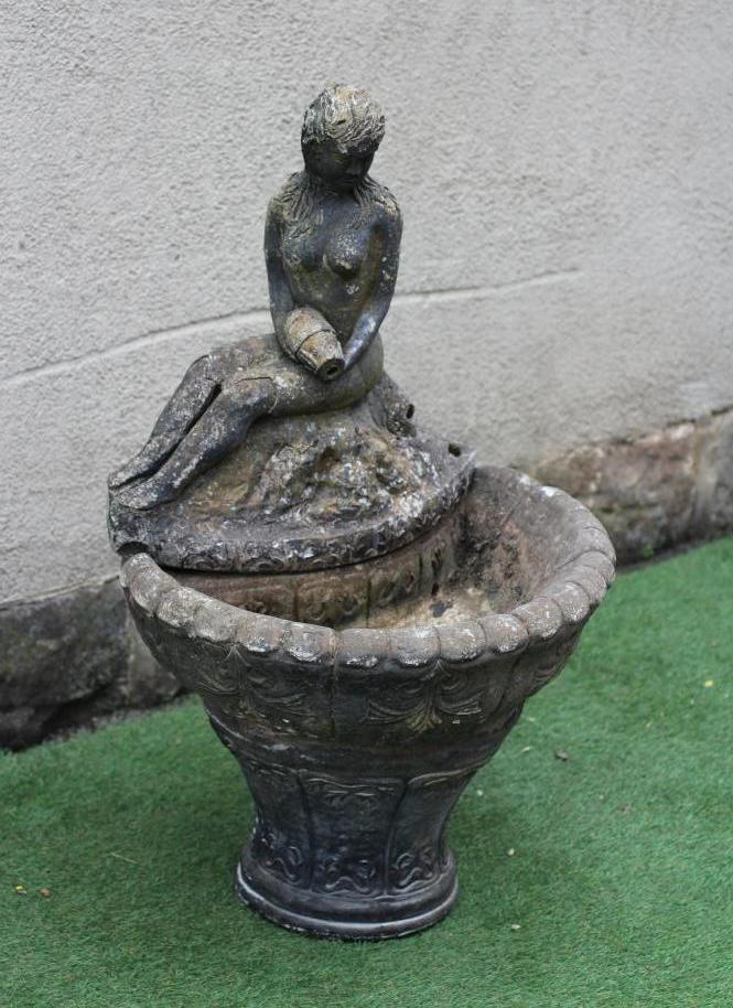 A CAST STONE WATER FEATURE modelled as an escallop shell surmounted by a seated nymph with water Image