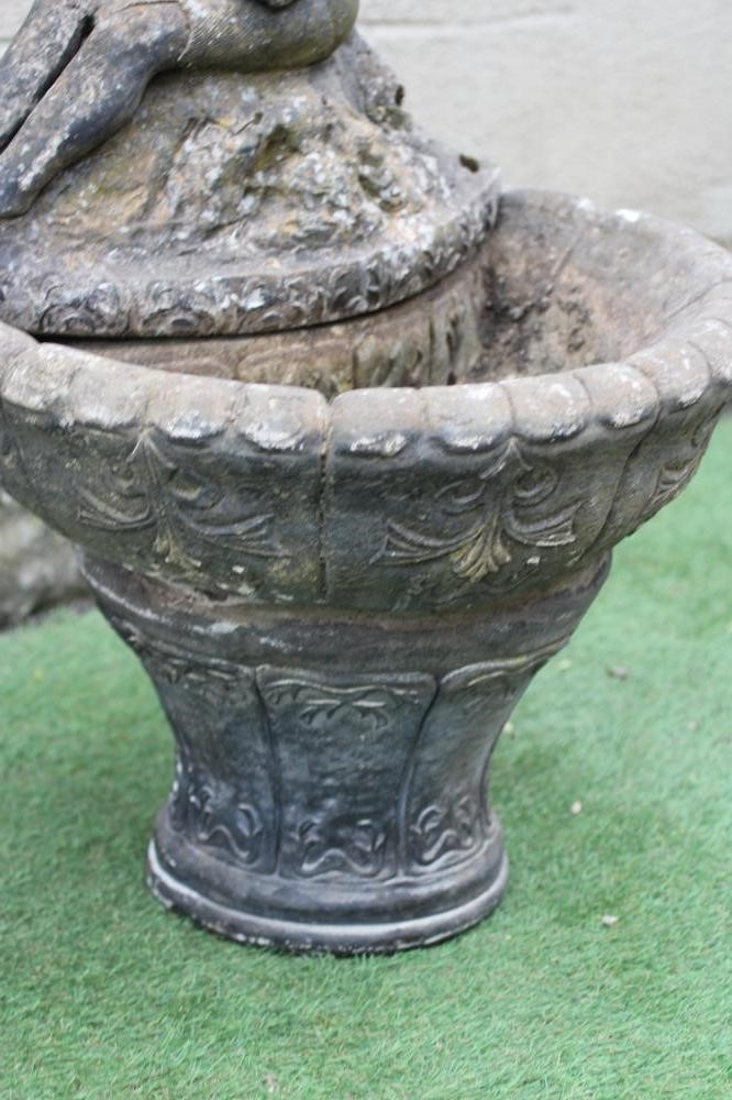 A CAST STONE WATER FEATURE modelled as an escallop shell surmounted by a seated nymph with water Image