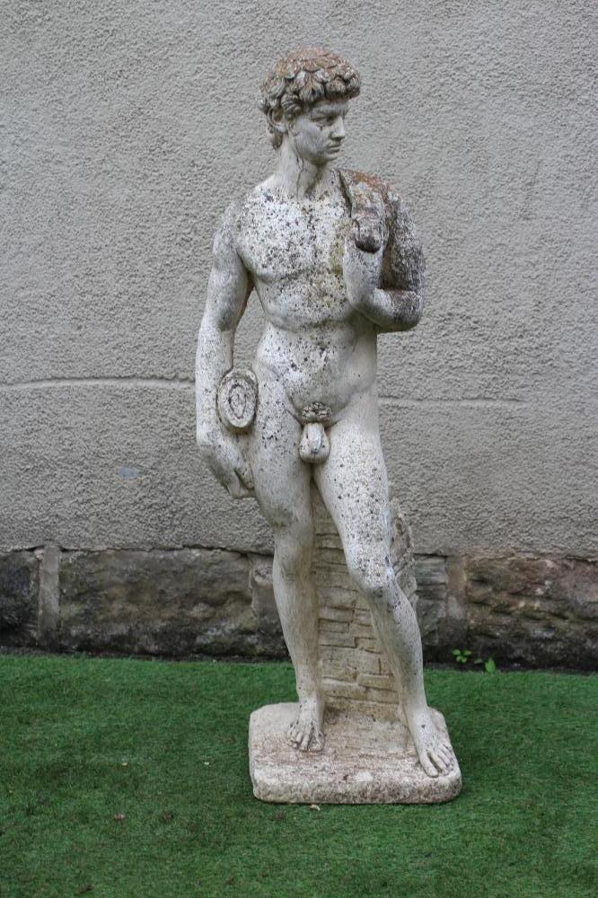 A CAST STONE FIGURE OF DAVID after Michelangelo, on an oblong base, 13" x 47 (Est. plus 24% premium Image