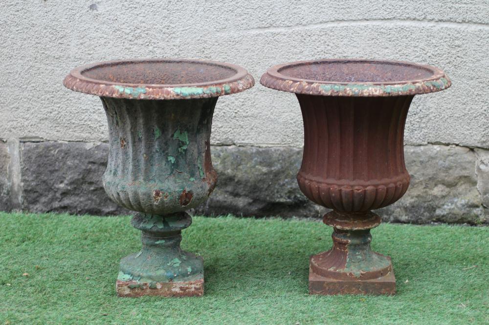 A PAIR OF VICTORIAN CAST IRON URNS of half fluted campana form with everted ovolo rim, waisted socle Image