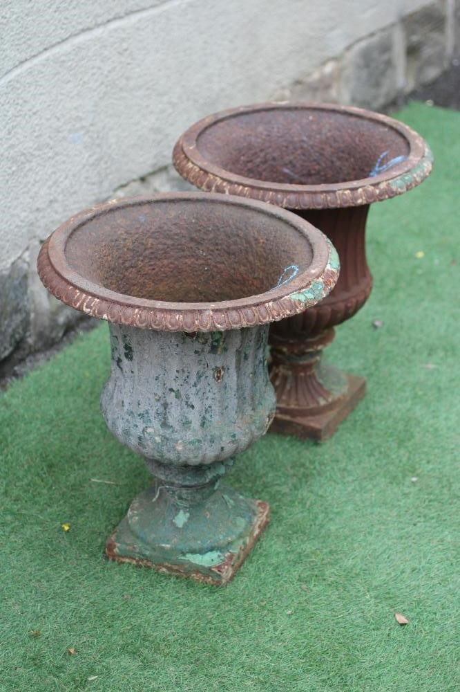 A PAIR OF VICTORIAN CAST IRON URNS of half fluted campana form with everted ovolo rim, waisted socle Image