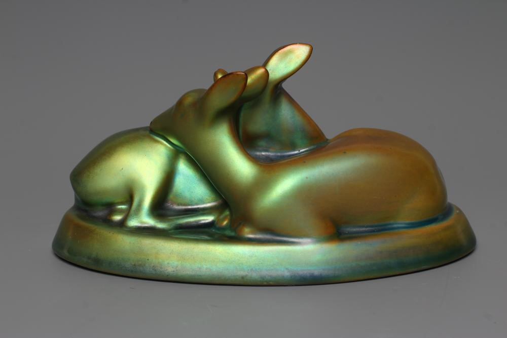A ZSOLNAY PECS GREEN IRIDESCENT POTTERY MODEL, mid 20th century, of two recumbent deer, printed gilt Image