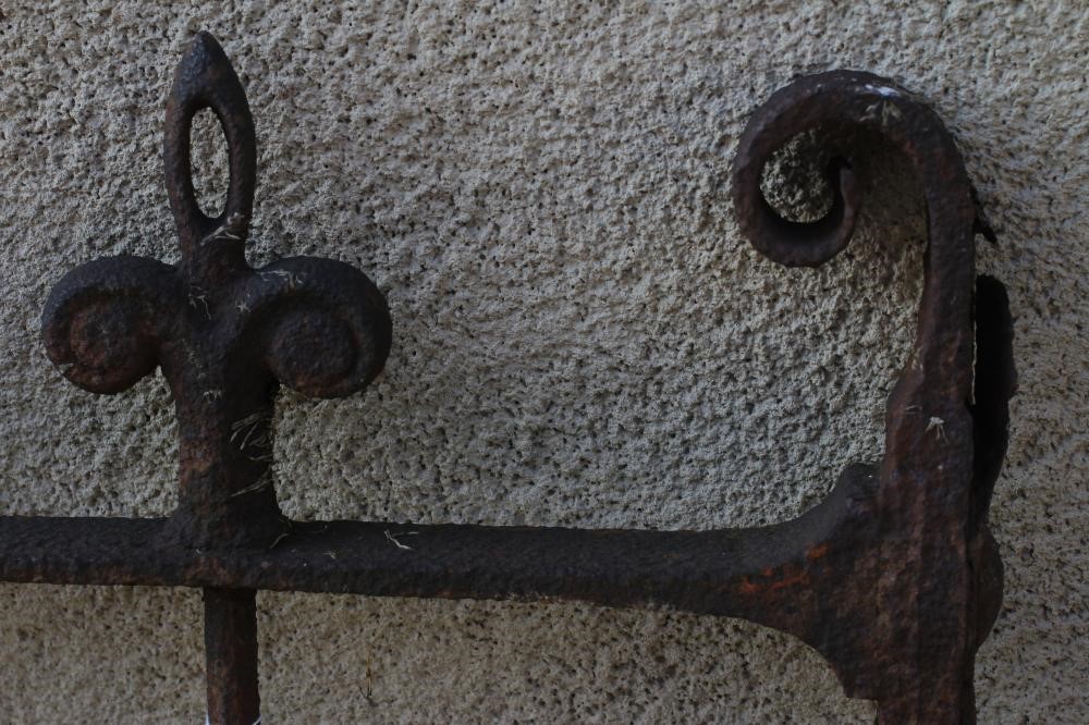 A VICTORIAN CAST IRON GARDEN GATE of two tier barred form with fleur de lys finials and scroll Image