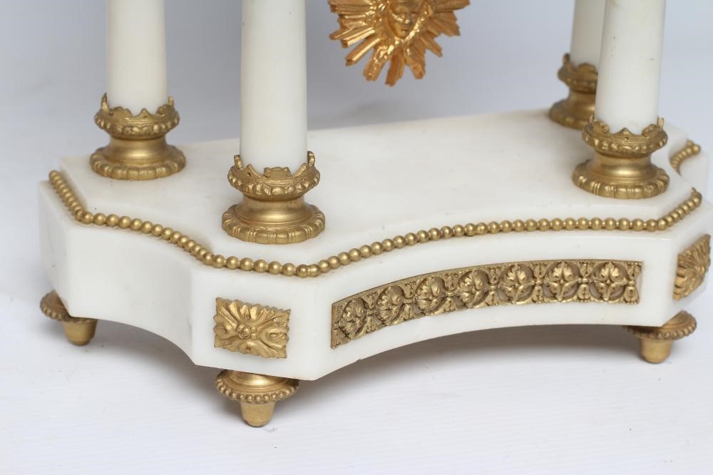 A GILT METAL AND WHITE MARBLE PORTICO CLOCK Image
