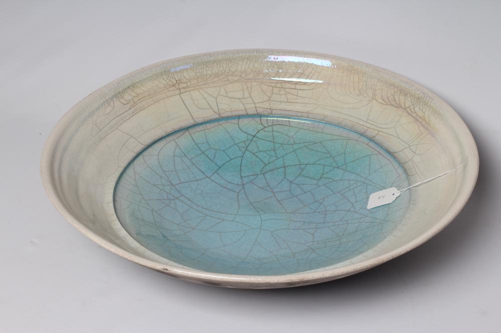 JOHN DUNN (b.1944) - a large Raku iridescent turquoise glazed stoneware circular dish, signed, 22" Image