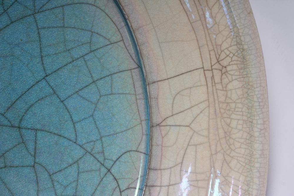 JOHN DUNN (b.1944) - a large Raku iridescent turquoise glazed stoneware circular dish, signed, 22" Image