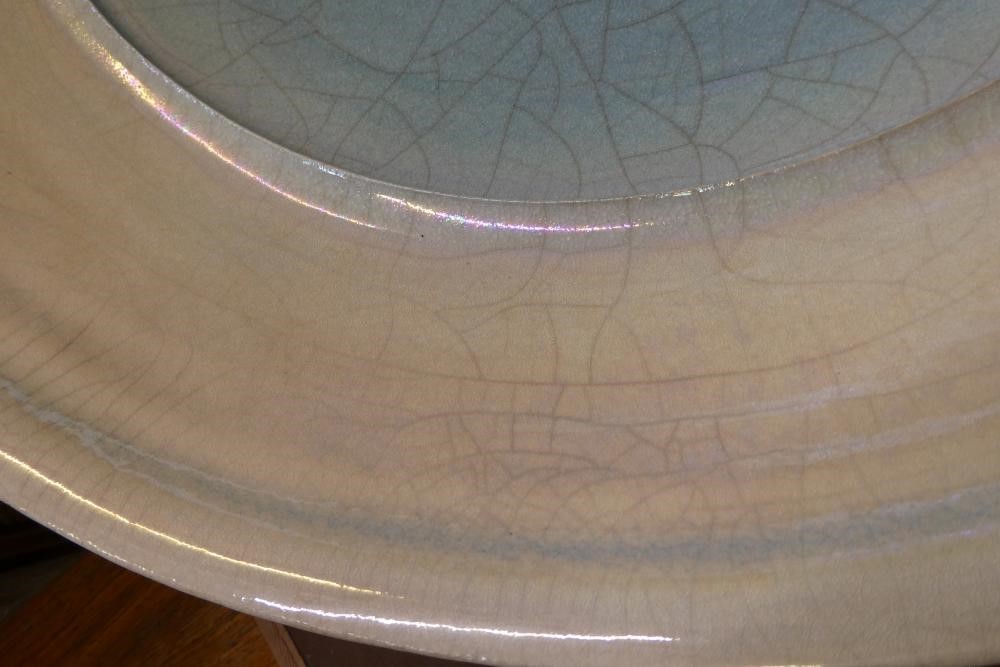 JOHN DUNN (b.1944) - a large Raku iridescent turquoise glazed stoneware circular dish, signed, 22" Image