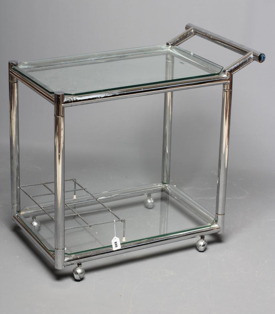 AN ART DECO CHROME TROLLEY of oblong two tier form with glass shelves, chrome bottle housing and Image