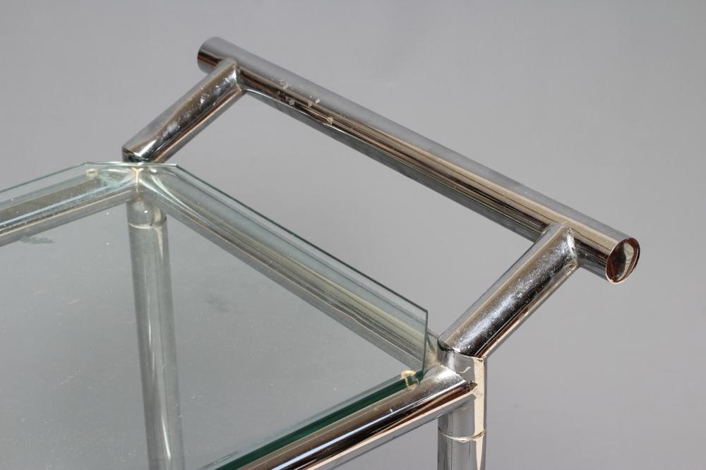 AN ART DECO CHROME TROLLEY of oblong two tier form with glass shelves, chrome bottle housing and Image