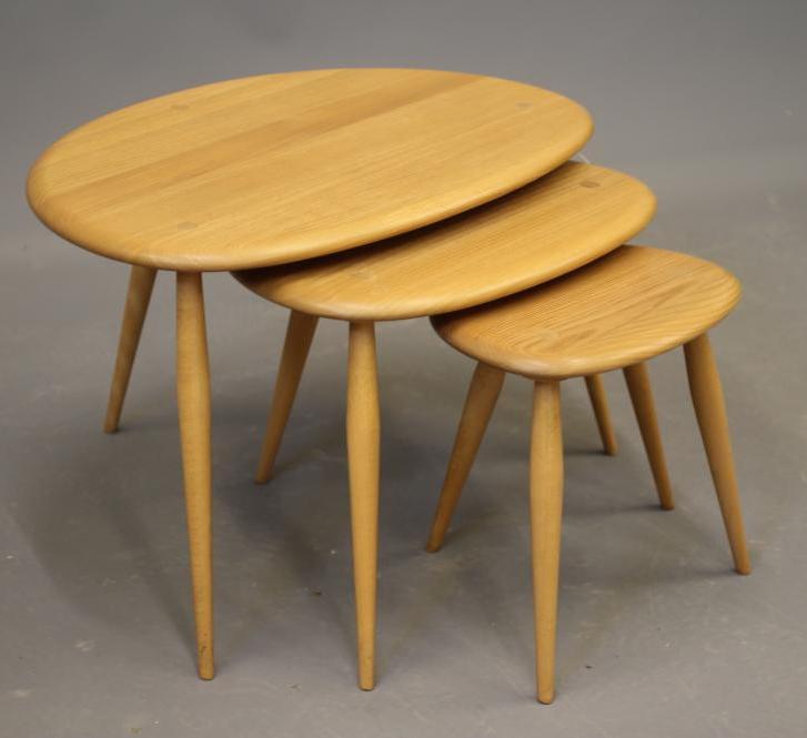 A nest of ercol model 354 elm "pebble" tables, raised on turned beech