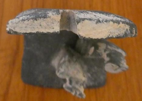 JOHN MALTBY (1936-2000) - a matt grey stoneware sculpture of two figures standing before a cut slab Image