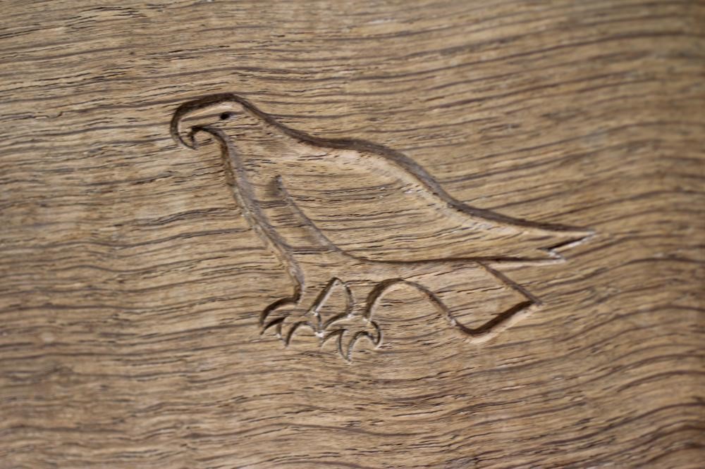 ALBERT JEFFRAY, AN ADZED OAK STOOL, of kidney form raised on three faceted splayed legs, incised Image