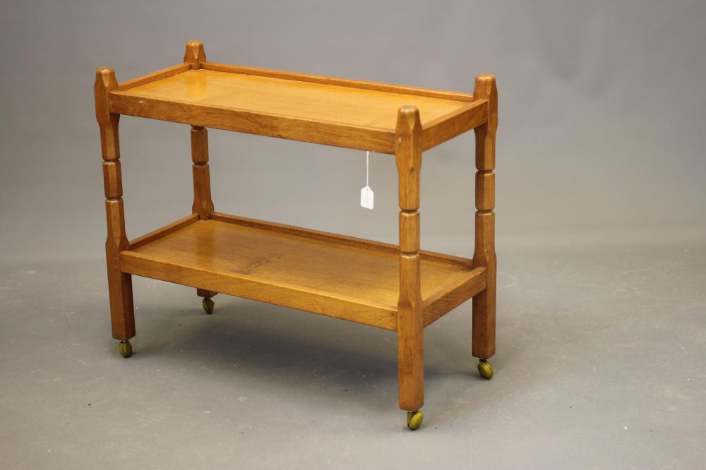MALCOLM PIPES, AN ADZED OAK TEA TROLLEY of oblong two tier form raised on four square turned faceted Image