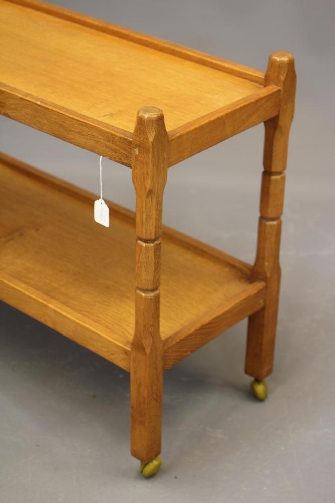MALCOLM PIPES, AN ADZED OAK TEA TROLLEY of oblong two tier form raised on four square turned faceted Image