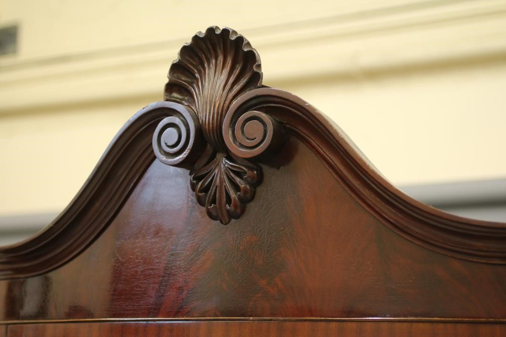 A MAHOGANY DISPLAY CABINET of bowed form Image