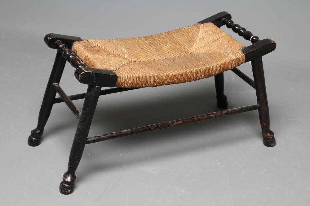 AN ARTS AND CRAFTS EBONISED RUSH SEATED STOOL Image