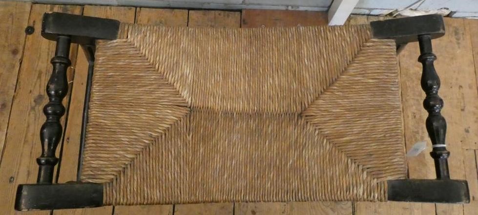 AN ARTS AND CRAFTS EBONISED RUSH SEATED STOOL Image