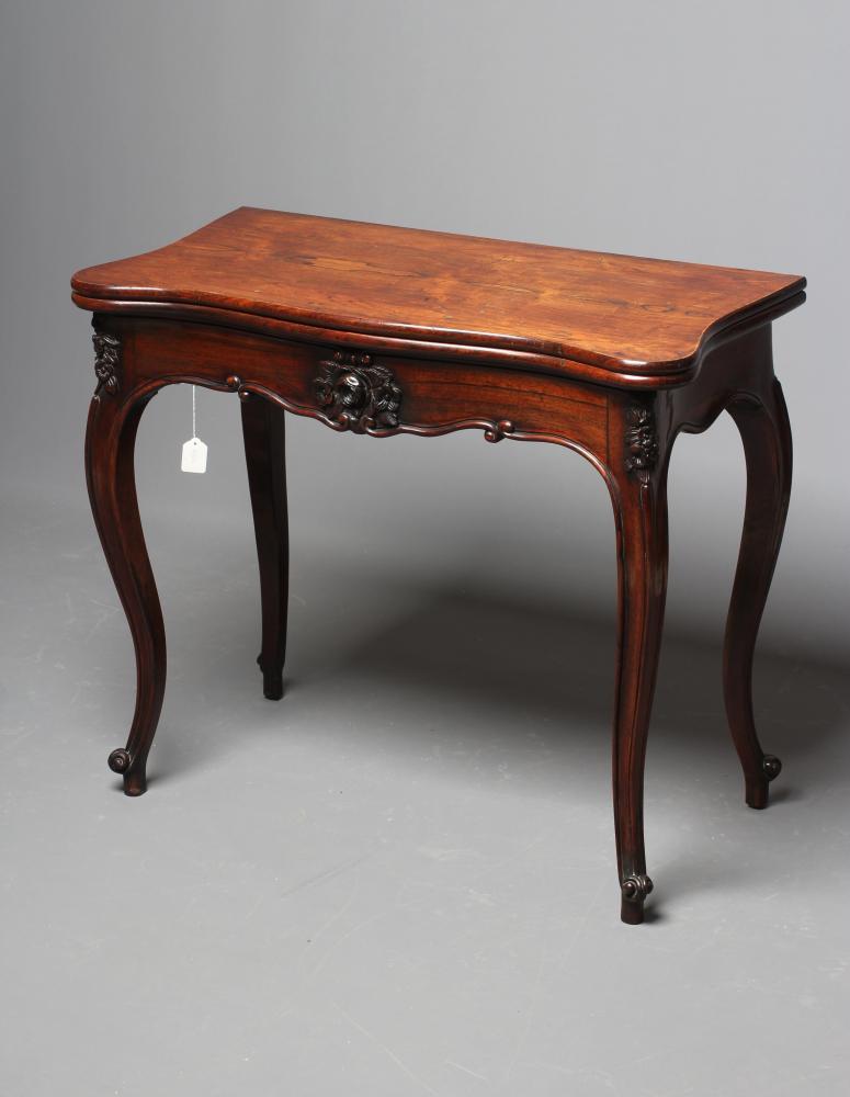 A VICTORIAN ROSEWOOD FOLDING CARD TABLE of serpentine oblong form Image