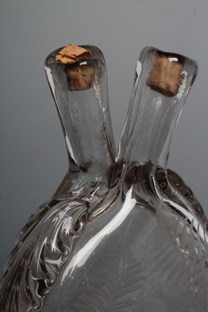A VICTORIAN ELIPTICAL GLASS FLASK with double spout and applied prunted edge Image
