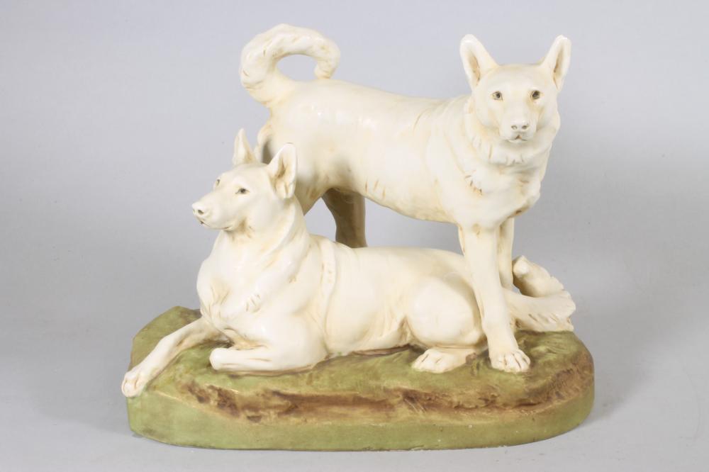 A ROYAL DUX PORCELAIN DOG GROUP modelled as two Japanese Hokkaido recumbent and standing Image
