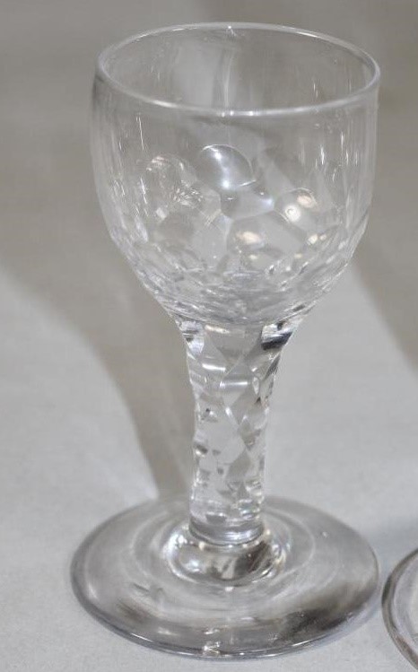 A COLLECTION OF FOUR GEORGIAN AND SLIGHTLY LATER DRINKING GLASSES comprising a panel moulded jelly Image