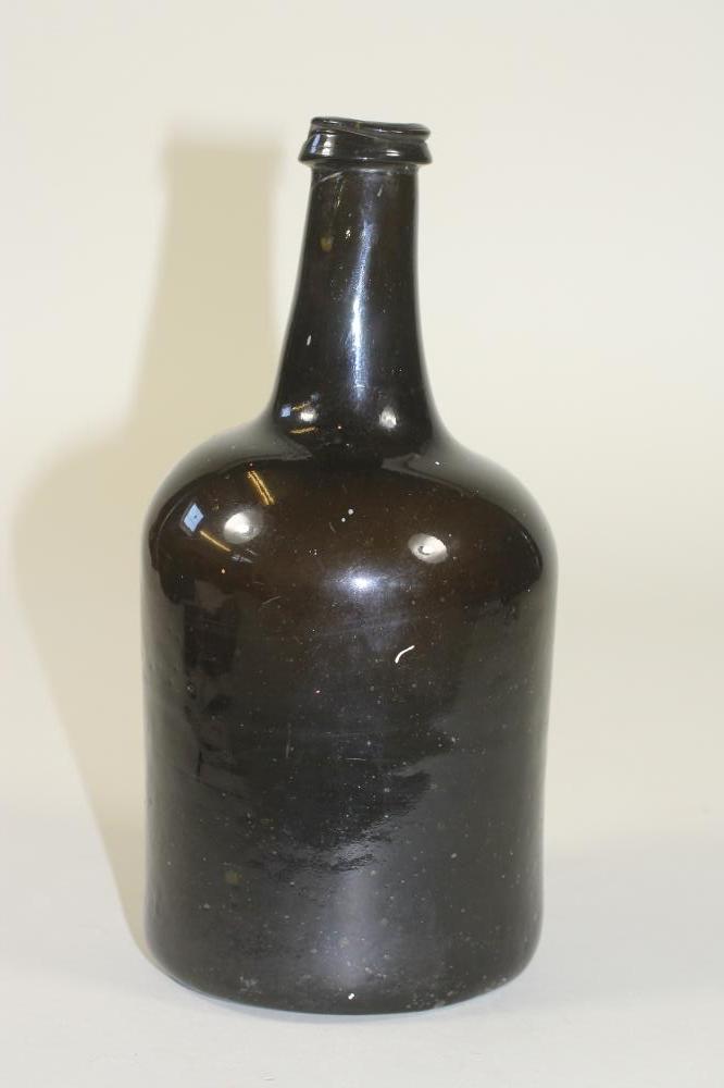 A DARK GREEN GLASS BOTTLE Image