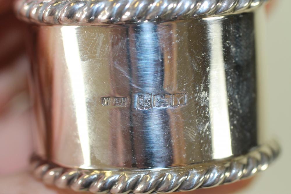 A SET OF FOUR SILVER NAPKIN RINGS Image