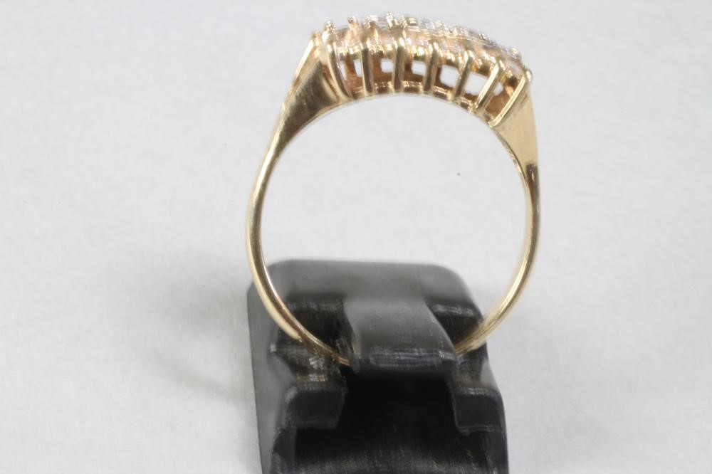 A DIAMOND DRESS RING centred by four (settings for five) graduated brilliant cut diamonds within Image