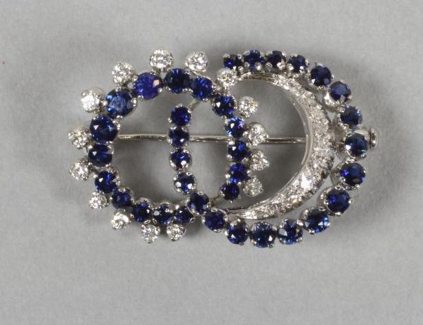 A SAPPHIRE AND DIAMOND DOUBLE CRESCENT BROOCH Image