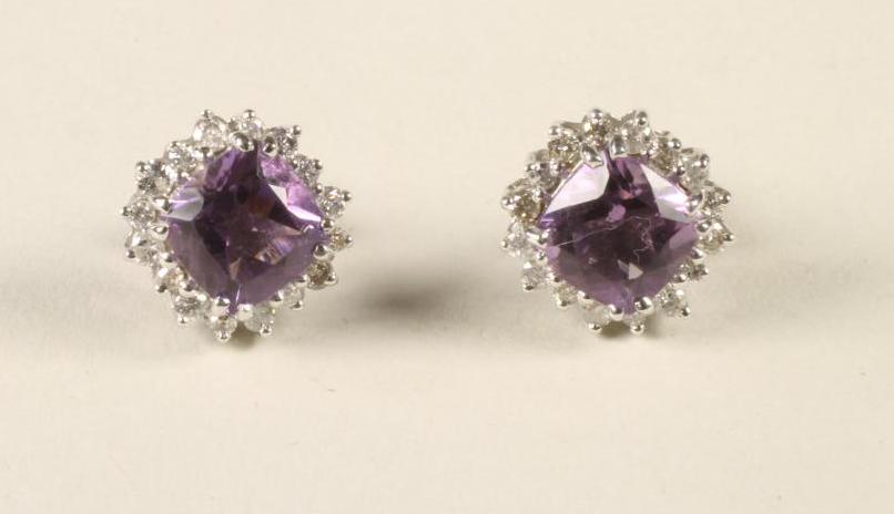 A PAIR OF AMETHYST AND DIAMOND CLUSTER EAR STUDS Image