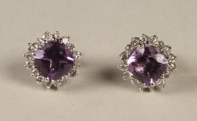 A PAIR OF AMETHYST AND DIAMOND CLUSTER EAR STUDS Image