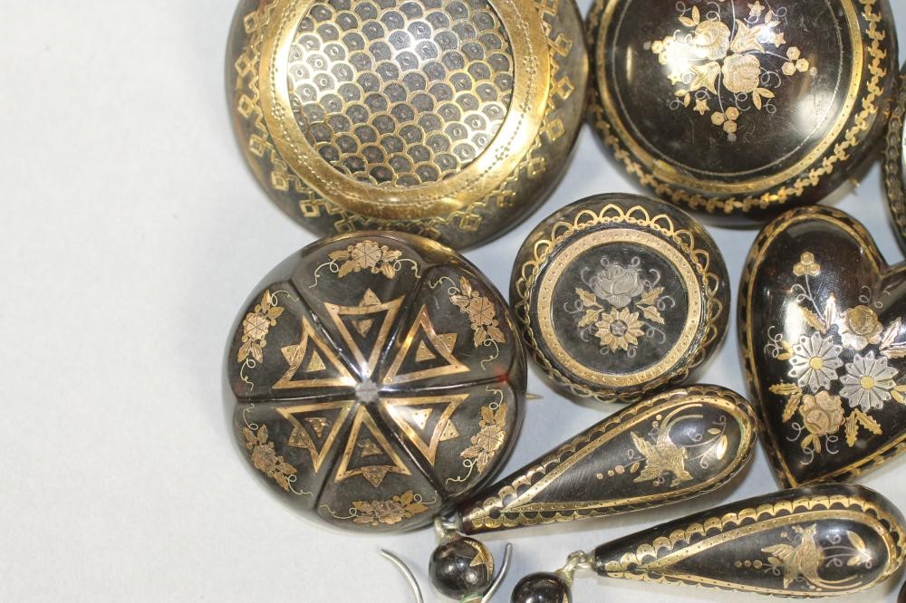 A COLLECTION OF VICTORIAN TORTOISESHELL PIQUE WORK JEWELLERY comprising six brooches and three pairs Image