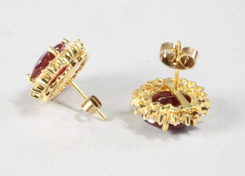 A PAIR OF RUBY AND DIAMOND EAR STUDS Image
