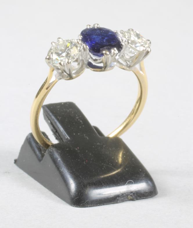 A SAPPHIRE AND DIAMOND THREE STONE RING Image