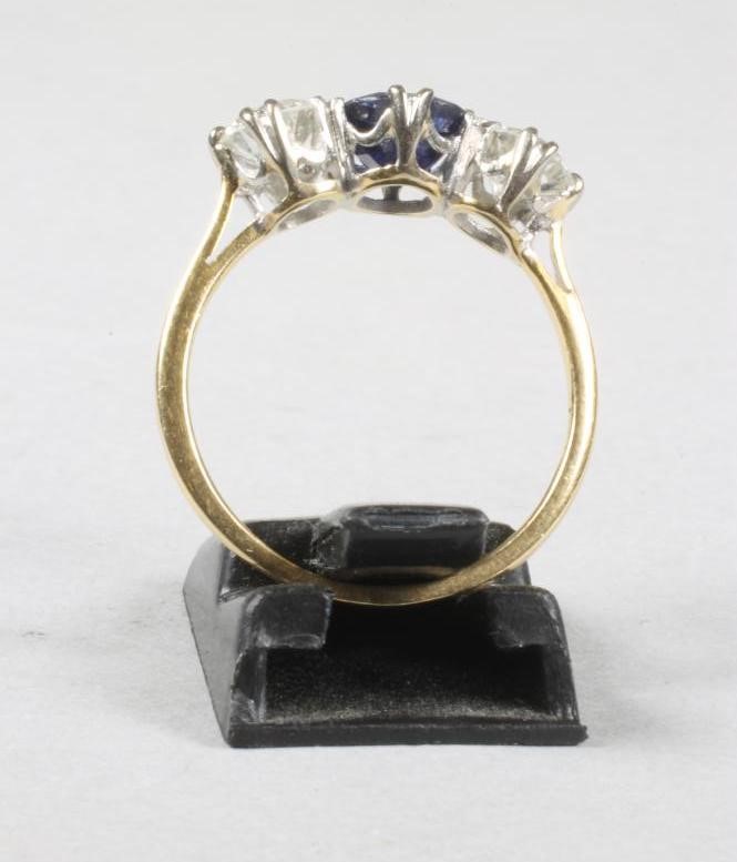A SAPPHIRE AND DIAMOND THREE STONE RING Image