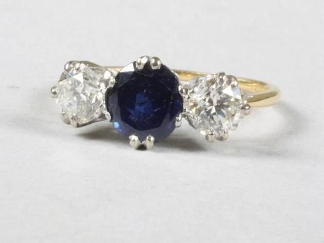 A SAPPHIRE AND DIAMOND THREE STONE RING Image