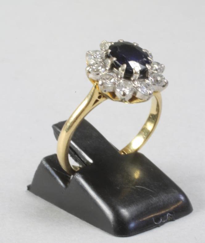A SAPPHIRE AND DIAMOND CLUSTER RING Image