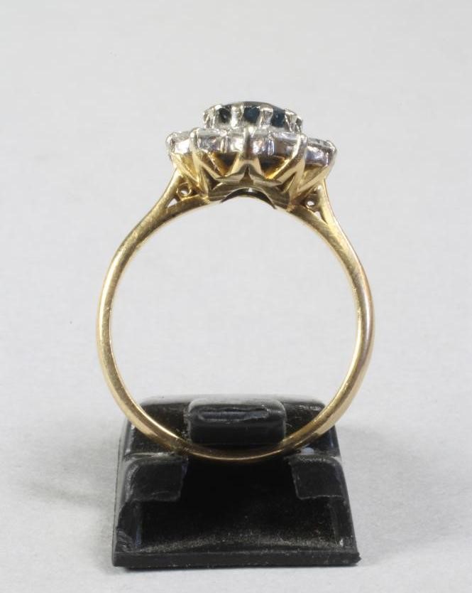 A SAPPHIRE AND DIAMOND CLUSTER RING Image