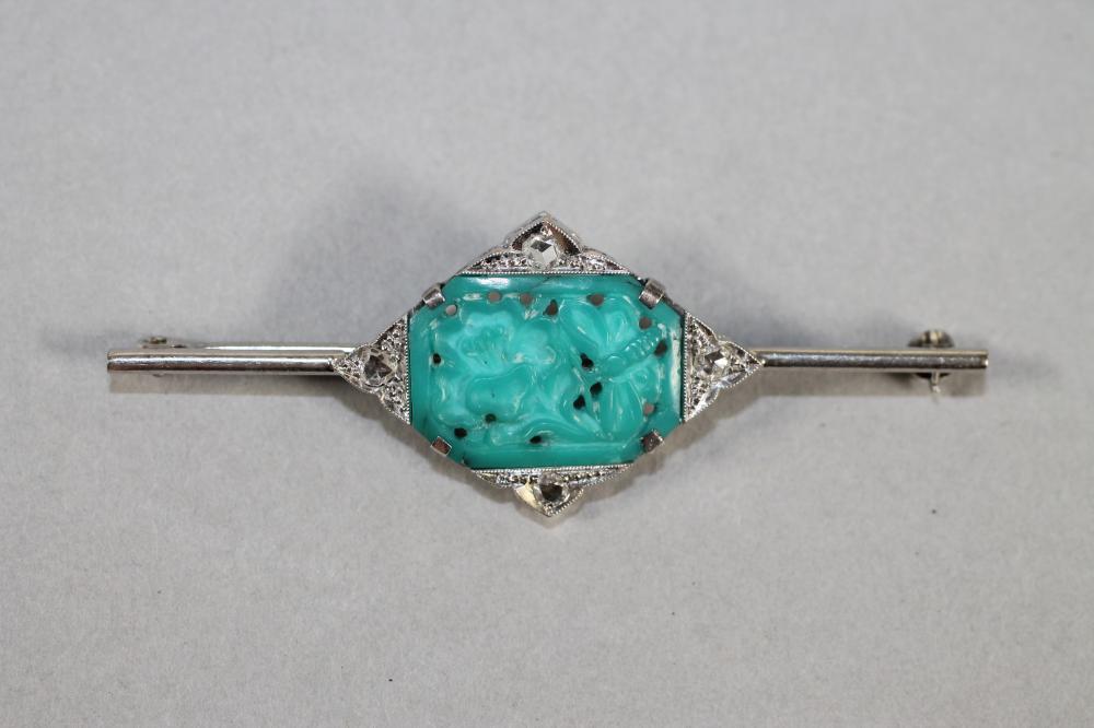AN ART DECO BAR BROOCH centred by an oblong turquoise panel pierced and carved with an insect and Image
